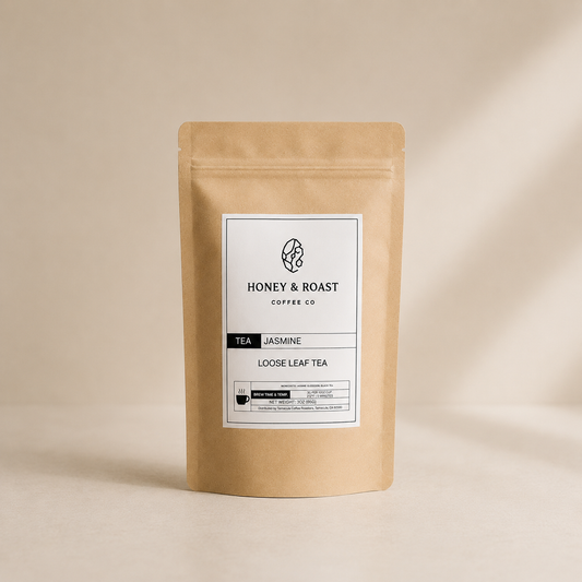 A kraft paper stand-up pouch of Honey & Roast Coffee Co. Jasmine Loose Leaf Tea, featuring a clean white label with black text, set against a warm beige background with soft shadows.