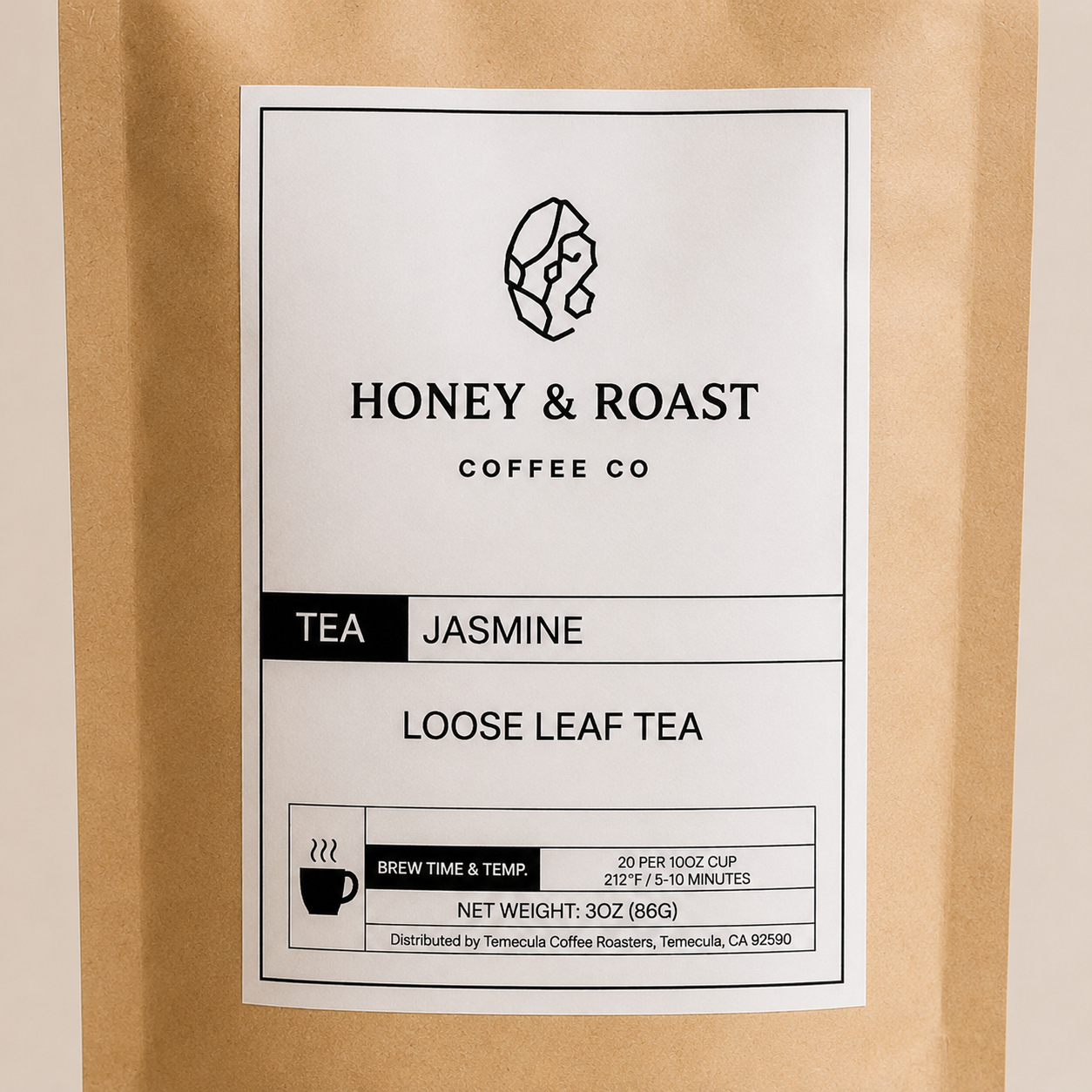A close-up of a Honey & Roast Coffee Co. Jasmine Loose Leaf Tea package, showing a white label on a brown kraft paper pouch.