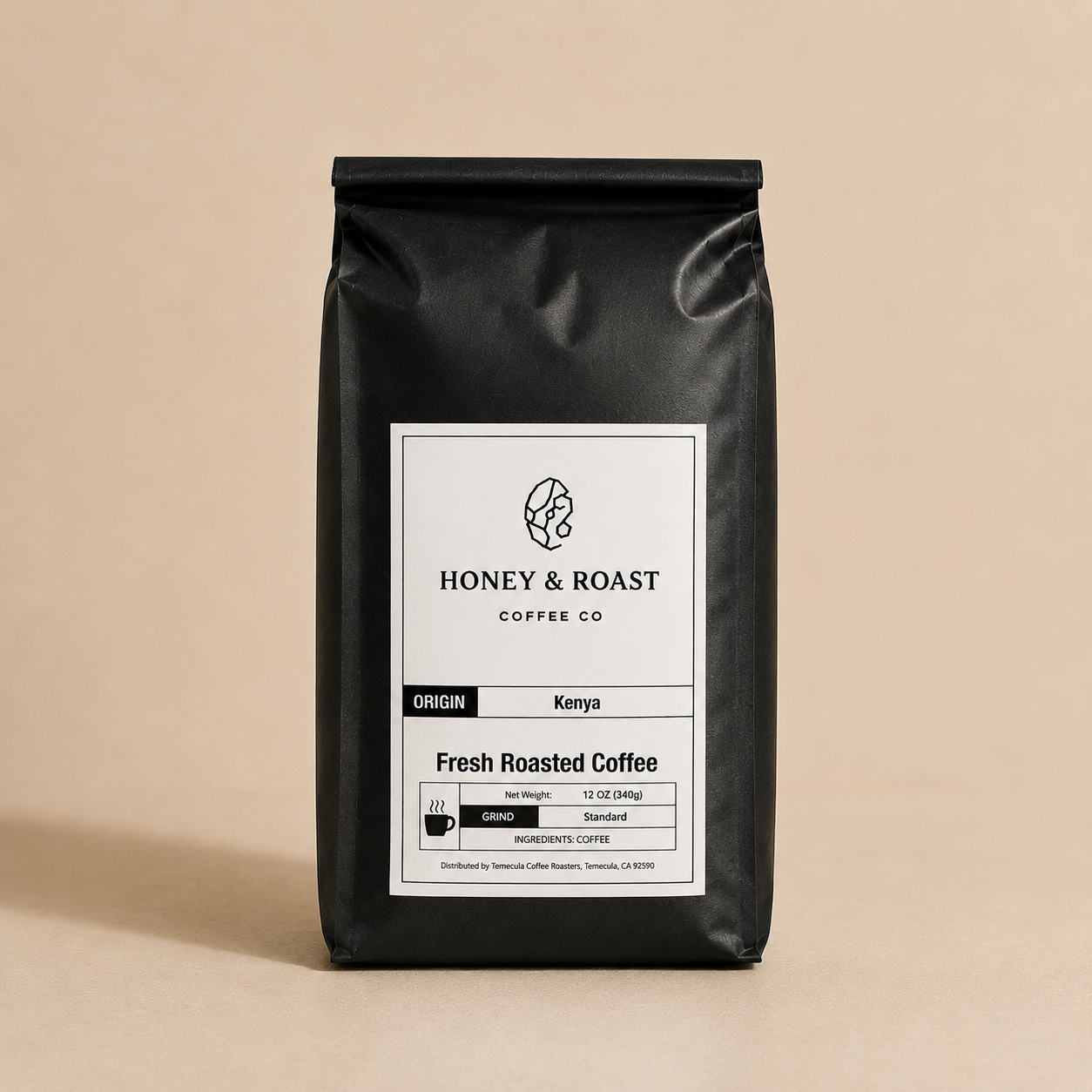 A black coffee bag with a white label from Honey & Roast Coffee Co., featuring Kenya as the origin and Fresh Roasted Coffee as the product type, set against a solid beige background.